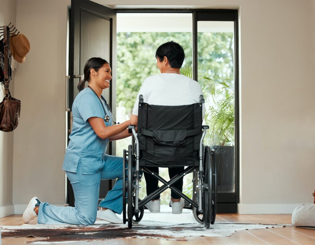 Shot of a young nurse caring for an older woman in a wheelchair